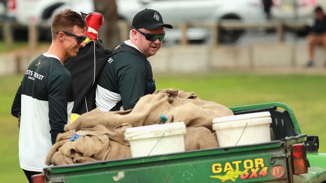 Western Suburb’s coaching staff Josh Clarke and Chadd Porter inspect equipment during a round of the AW Green Shield.