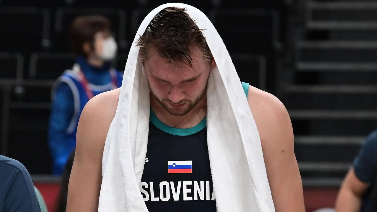 A dejected Luka Doncic walks off the court. (Photo by Aris MESSINIS / AFP)