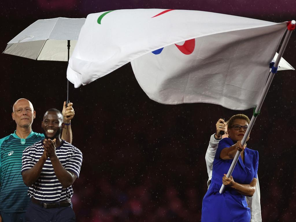 Karen Bass, Mayor of Los Angeles, waves the Paralympic Flag next to US athlete Blake Leeper. Picture: Steph Chambers/Getty Images