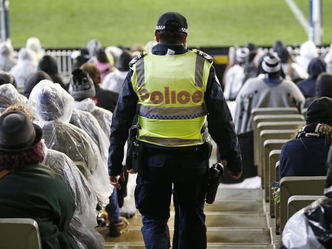 Operation Tennyson public order/liquor licensing operation that runs across the Yarra area during marquee AFL matches and all major events at the MCG.  A Police officer patrol up and down the aisles for trouble during the Collingwood vs Richmond game. Picture: David Caird