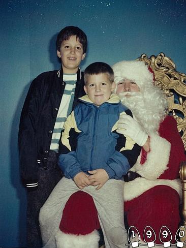 1990 ... Even with braces on his teeth, Mike grinned with glee alongside Santa and Martin. Picture: Martin Gray 