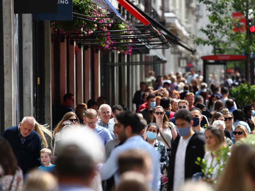 LONDON, ENGLAND - JULY 31: Shoppers walk along Regent Street on July 31, 2021 in London, England. The United Kingdom, considered one of the advanced world's worst hit economies by the pandemic, is predicted by the IMF to a 7% growth increase since Covid-19 lockdown measures were eased on 19th July. People are still expected to observe social distancing and wear masks but these are no longer mandatory. (Photo by Hollie Adams/Getty Images)