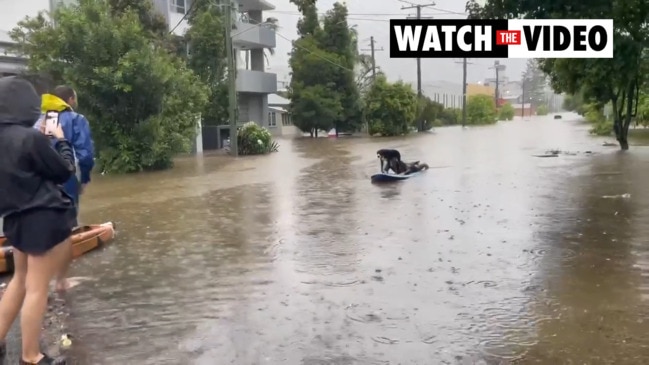 Brisbane residents rescue each other on surfboards