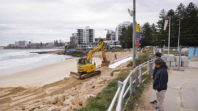 Workers at Cronulla Beach fill the sand area with rocks after huge swells caused massive erosion. Picture: Sam Ruttyn