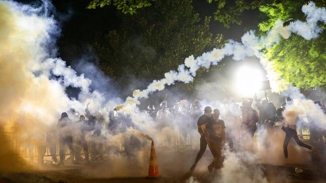 Tear gas rises above as protesters face off with police during a demonstration outside the White House.