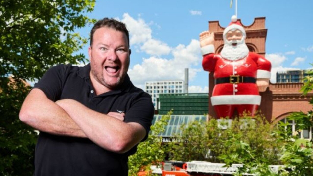 Andrew "Cosi" Costello in front of the big Santa at the Adelaide Central Markets Picture: Matt Loxton