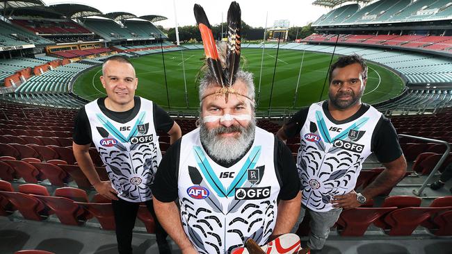 Former Port players Shane Bond, Michael O’Brien and Byron Pickett at Adelaide Oval wearing the Indigenous jumper that has their names printed on it. Picture: Mark Brake