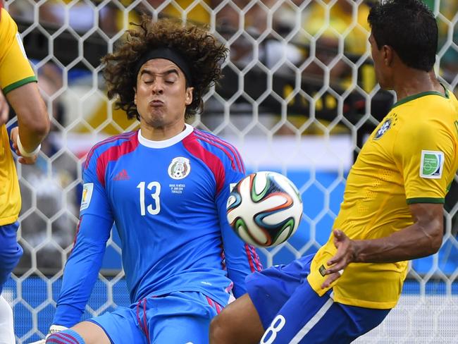 Mexico's goalkeeper Guillermo Ochoa (C) kicks the ball during a Group A football match between Brazil and Mexico in the Castelao Stadium in Fortaleza during the 2014 FIFA World Cup on June 17, 2014. AFP PHOTO / ODD ANDERSEN