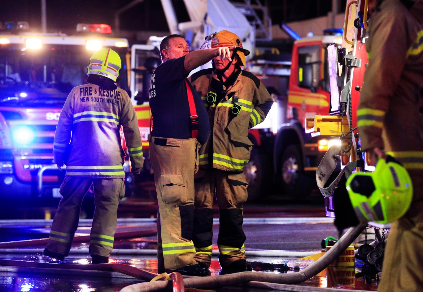 NSW Fire and Rescue Officer directs Queensland Fire Brigade Officers who were assisting local Kingscliff and Tweed Fire and Rescue Units to fight the fire at the Cudgen League Club Kingscliff .Photo Scott Powick Newscorp