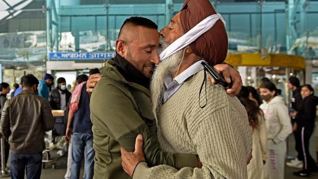 A man from Britain receives a hug from his father after he went through a COVID-19 coronavirus test at Sri Guru Ram Dass Jee International Airport in India. Picture: AFP