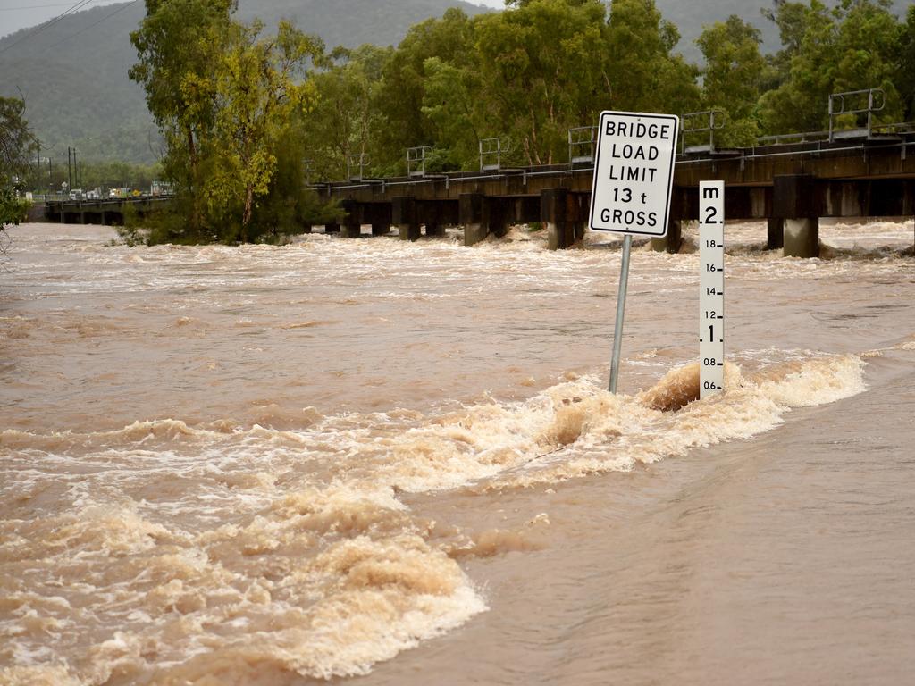 At least 14 flood alerts have been issued in Queensland, including waterways near Townsville, where Rollingstone Creek was over the Bruce Highway on Tuesday. Picture: Evan Morgan