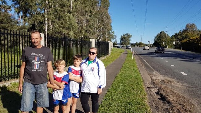 Kylie and Tom Reise outside their Chambers Flat property, which has a new fence which will be ploughed through when the road is widened.