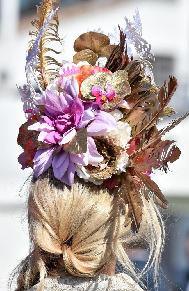 A woman sports a fancy hat at Flemington Racecourse on Melbourne Cup day in Melbourne on November 3, 2015. Picture: AFP PHOTO/Paul CROCK