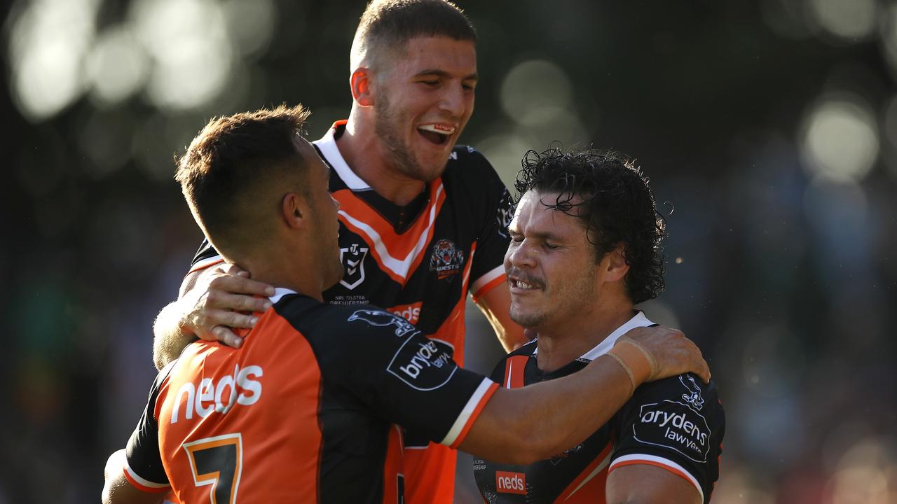 Luke Brooks, Adam Doueihi and James Roberts celebrate during their huge trial win over the Sea Eagles.