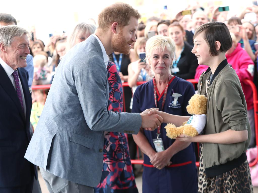 Former patient Daisy Wingrove, 13, gives Prince Harry a gift for baby Archie. Picture: Chris Jackson/Getty Images