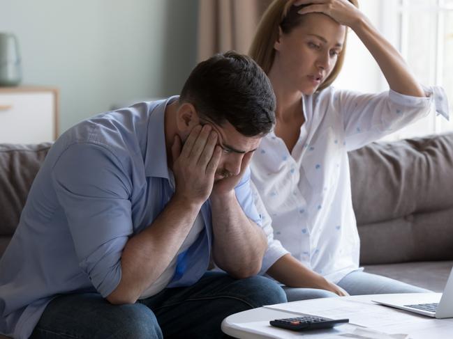 Stressed spouses manage family finances, analyze expenses, check savings and budget, looks disappointed due to mortgage arrears, unpaid utility bills, debt notice. Lack of money, high utility concept