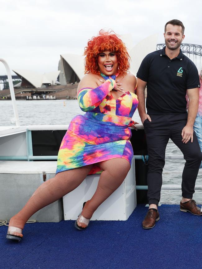 Coco Jumbo (red hair short dress) Simon Dunn (black shirt) on Sydney harbour to promote a show on Pride Cruises. Picture Rohan Kelly.