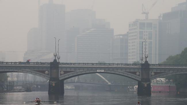 Bushfire smoke haze and light rain hang over the Melbourne CBD. Picture: David Crosling