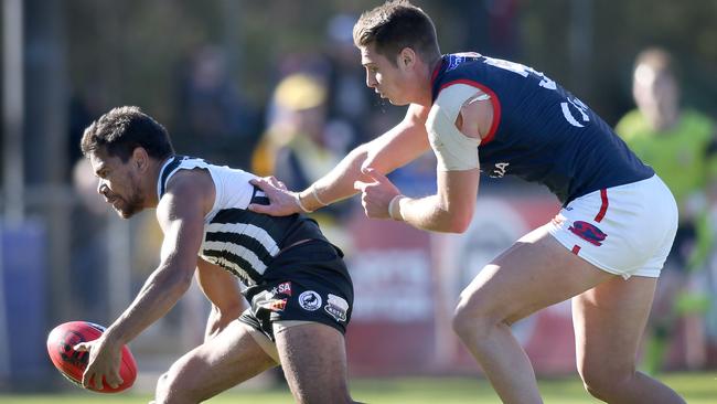 Port Adelaide’s Jake Neade tries to give Norwood defender Michael Talia the slip.