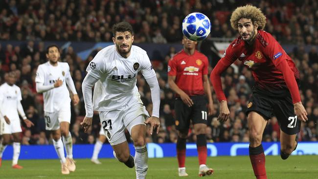 Manchester United midfielder Marouane Fellaini races for the ball with Valencia defender Cristiano Piccini at Old Trafford. Picture: AP