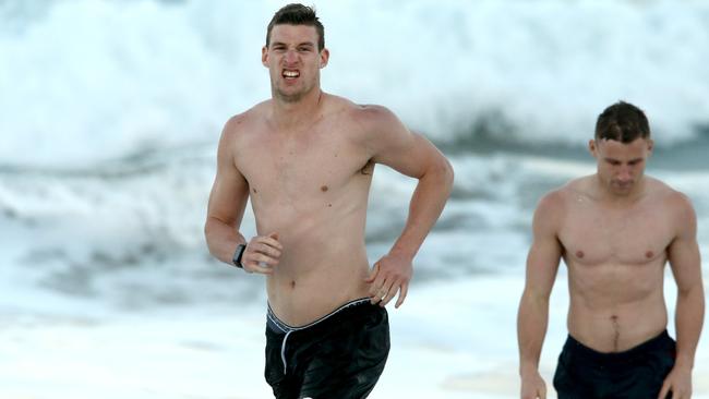 Crows Josh Jenkins and Rory Laird on the beach at the Gold Coast. Picture David Clark/AAP