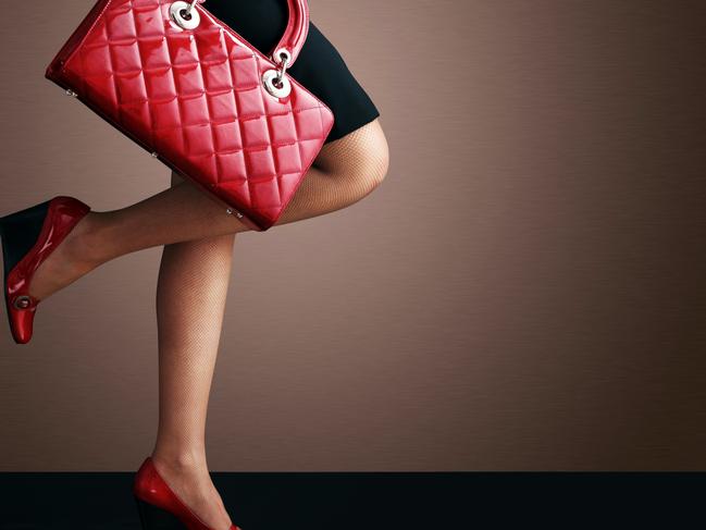 Extra Large file size.Woman sexy legs with handbag. Shopping and business
