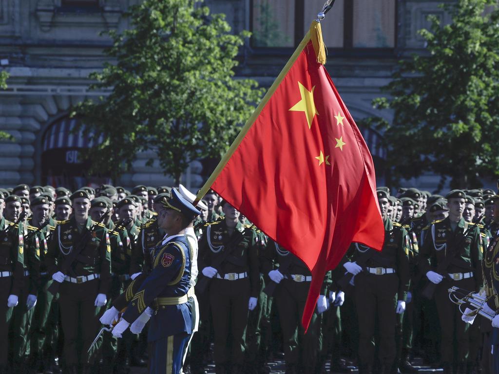 Soldiers from China's People's Liberation Army carry a flag ahead of the Victory Day military parade marking the 75th anniversary of the Nazi defeat on Red Square in Moscow. Picture: AP Photo/Pavel Golovkin, Pool.