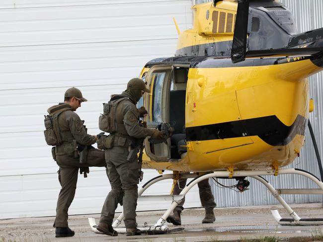 Gillam Police rush to a helicopter to search for the fugitives. Picture: Clint Brewer/News Corp Australia