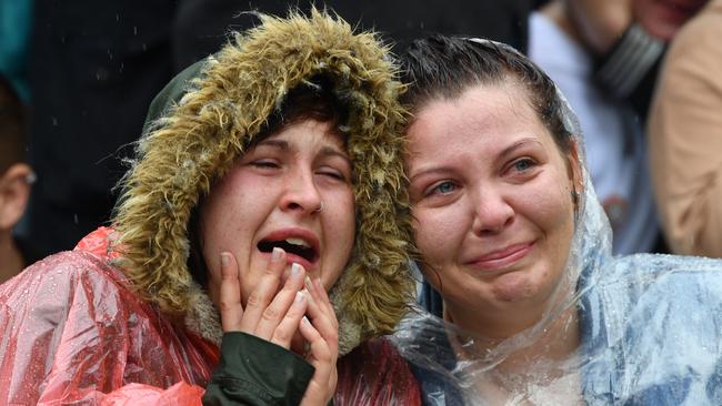 A couple reacts with tears of joy at the marriage equality rally in Hindmarsh Square, Adelaide. Picture: David Mariuz/AAP