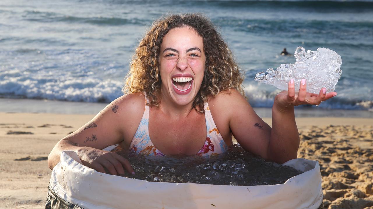 Deb Sarah Mendelhson braves the early morning chill as she hops into an ice bath on the usually warm Bronte Beach in Sydney at sunrise. Picture: Gaye Gerard