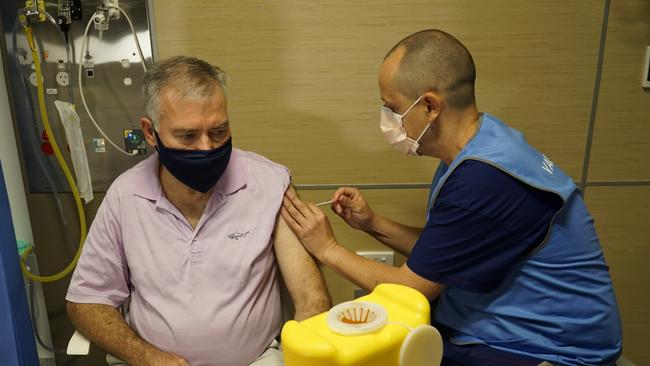 Health Minister Stephen Wade receives vaccine from Ben Cahill. Source. Supplied.