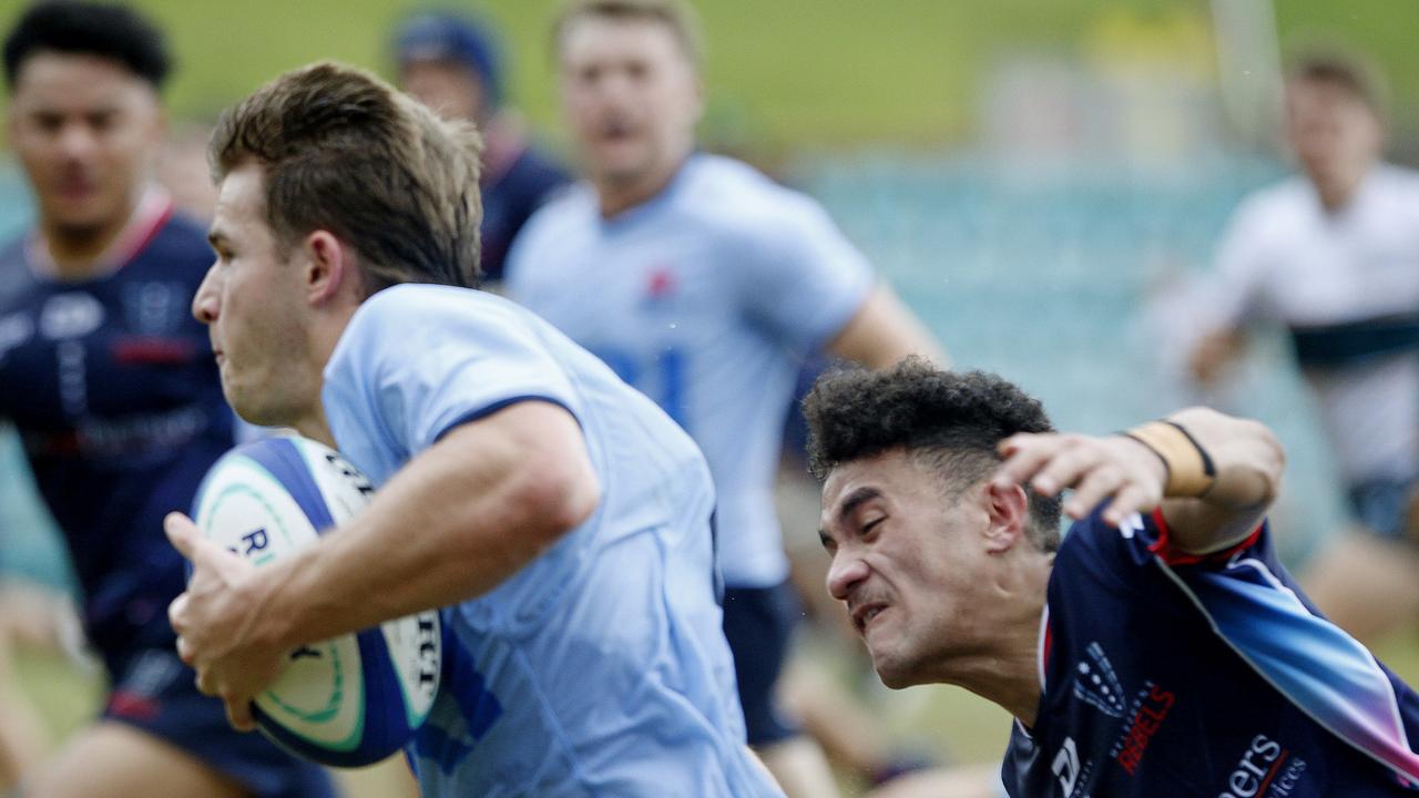 Waratahs' Liam Grover being chased by Melbourne Rebels' Journey Ioane in the U19s Super Rugby comp. Picture: John Appleyard.