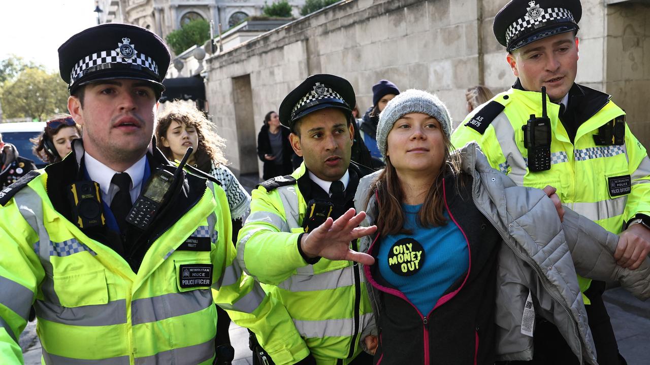 Swedish climate activist Greta Thunberg is arrested outside the InterContinental London Park Lane during the "Oily Money Out" demonstration organised by Fossil Free London on October 17, 2023. (Photo by HENRY NICHOLLS / AFP)