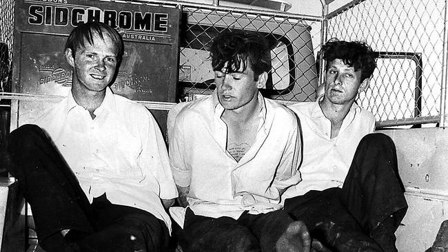 Prison escapees (left to right) Terrence Haley with Raymond Gunning and Murray Brooks handcuffed in back of truck after their capture on Birdsville Track 14 Sep. 1970. Picture: Supplied