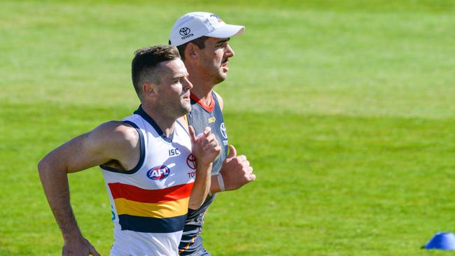 Ex-teammates Brad Crouch and Taylor Walker sprint during Adelaide Crows training. Picture: Brenton Edwards