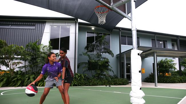 Shavinta Bann, 14, from Thursday Island, and Delwyn Scholes, 17, from Mornington Island, play some one-on-one basketball after school on the campus halfcourt. Picture: Brendan Radke