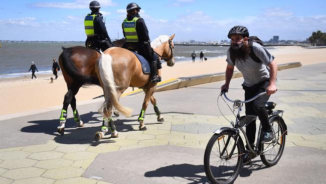 Police patrol St Kilda Esplanade in Melbourne on Monday. Picture: AFP