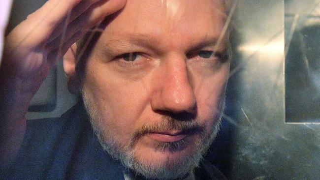 (FILES) In this file photo taken on May 01, 2019 WikiLeaks founder Julian Assange gestures from the window of a prison van as he is driven out of Southwark Crown Court in London, after having been sentenced to 50 weeks in prison for breaching his bail conditions in 2012. - Julian Assange has been subjected to drawn-out 