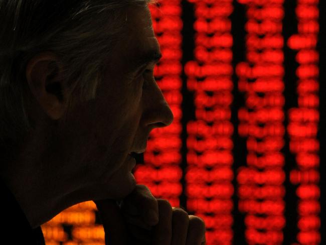 19/05/2010 WIRE: A concerned investor looks at a sea of red (indicating falling share prices) on a display at the Australian Stock Exchange (ASX) in Sydney 19/05/2010.