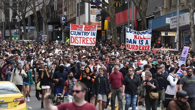 Protesters march through the streets during an anti-lockdown rally that descended into violence on Saturday. Picture: William West