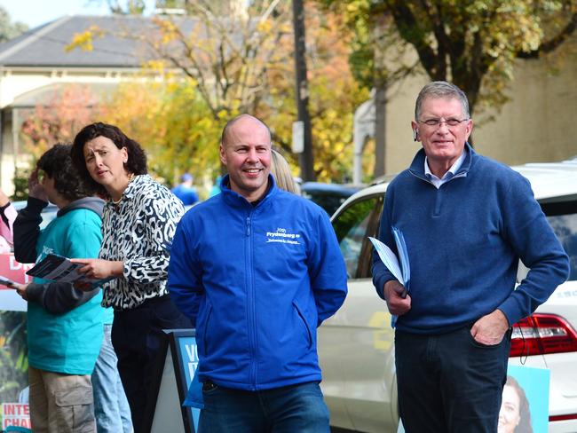 Australian Federal Treasurer Josh Frydenberg visits the pre-polling booth in Hawthorn, Melbourne, with former Premier of Victoria Ted Baillieu and independent candidate Monique Ryan behind. Picture: NCA NewsWire / Nicki Connolly