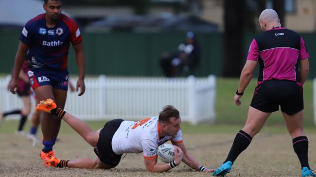 The Oaks Tigers No. 6 Mitch Brasington scores his second try. Picture: Steve Montgomery