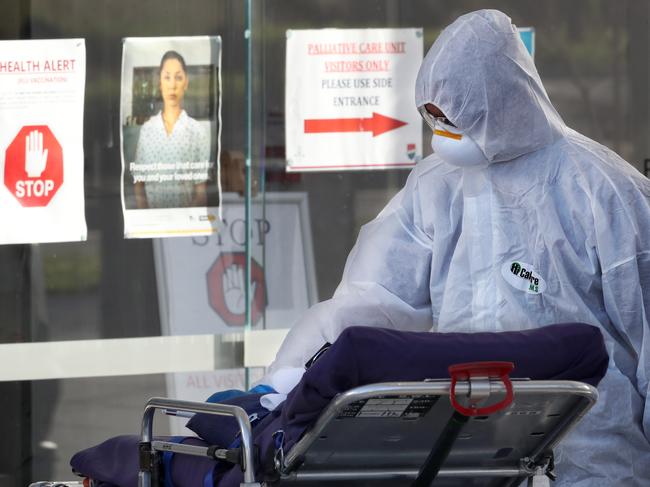 MELBOURNE, AUSTRALIA - NewsWire Photos JULY 30, 2020: A medical worker takes a trolley into Epping Gardens Aged Care home which has a COVID-19 breakout. Picture: NCA NewsWire /David Crosling