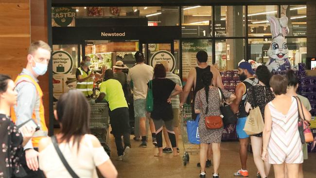 Customers line up outside a Brisbane Woolworths last year at the start of a lockdown. In December Woolworths revealed pandemic-related costs had blown out to as much as $220m in the first six months. Photographer: Liam Kidston