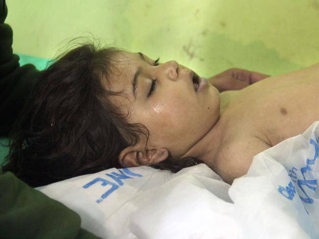 An unconscious Syrian child receives treatment at a hospital in Khan Sheikhun, a rebel-held town in the northwestern Syrian Idlib province, after a suspected toxic gas attack. Picture: AFP/Omar haj kadour