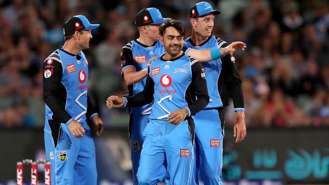  Striker Rashid Khan celebrates taking the wicket of Sydney Sixers captain Moises Henriques on Sunday. Picture: JAMES ELSBY (AAP).