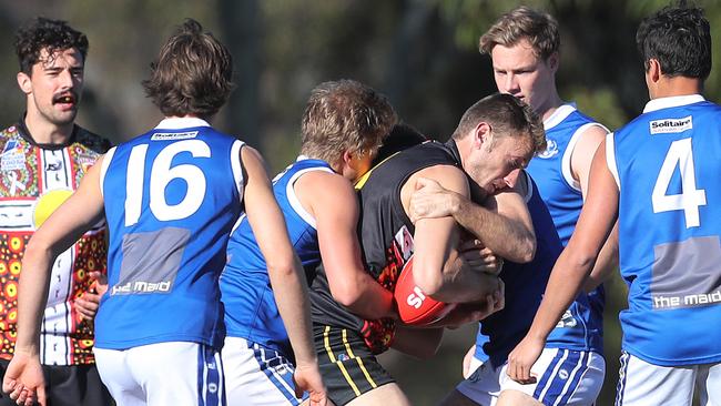 Goodwood's Travis Tuck gets trapped by St Peter’s players. Picture Dean Martin