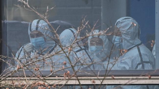 Members of the World Health Organization (WHO) team investigating the origins of the Covid-19 coronavirus, wearing protective gear are seen during their visit to the Hubei Center for animal disease control and prevention in Wuhan.