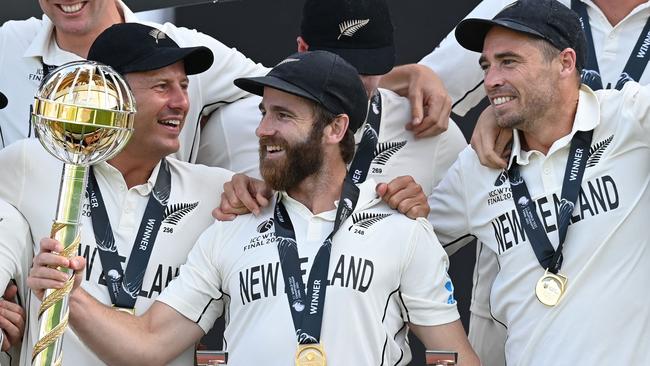 Captain Kane Williamson holds the winner's Mace as New Zealand players celebrate victory on the final day of the ICC World Test Championship Final in England