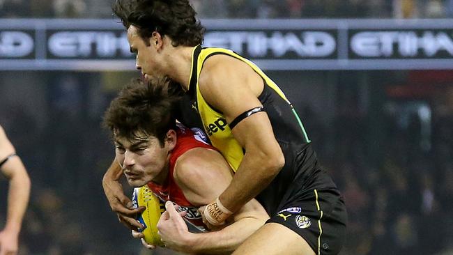 Sydney's George Hewett cops a bit of manhandling himself as Richmond's Daniel Rioli applies a tackle. Picture: Michael Klein